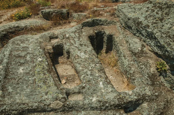 Ancient tombs for child and adult carved in stone near Monsanto — Stock Photo, Image