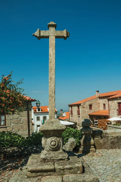 Picota en forma de cruz hecha de piedra en el patio y casas antiguas — Foto de Stock