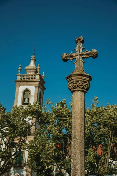 Torre sineira barroca da igreja e pelourinho de pedra com cruz — Fotografia de Stock