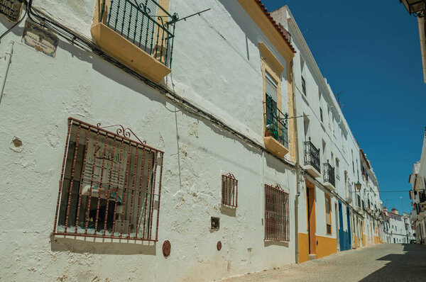 Campo Maior, Portugal - July 08, 2018. Old colorful houses with deserted alley in a narrow alley at Campo Maior. A cute little town with Roman, Moorish and medieval influences in eastern Portugal.