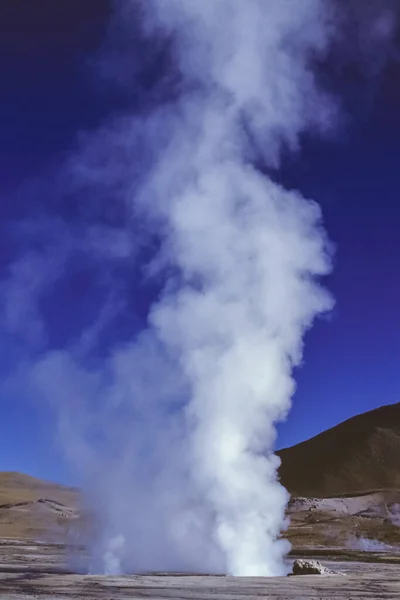 Water steam at the El Tatio geysers field in the Atacama desert highland. An extremely arid and mountainous region in northern Chile.