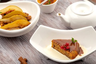 ahşap bir tepsi üzerinde, hafif bir arka planda beyaz bir plaka krem üzerinde tarih Cupcake