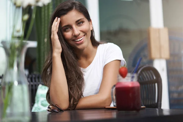 Entertained attractive girlfriend laughing happily touch haircut flirty lean coffee table sit outdoor terrace cafe drink strawberry smoothie drink enjoying nice conversation meet man dating app