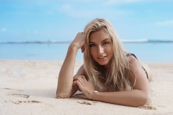 Close-up charming sensual blond caucasian woman wearing bikini lie down sandy beach coverd sand look camera delighted sunbathing, swim ocean enjoy paradise vacation, summer seaside — Stok Foto