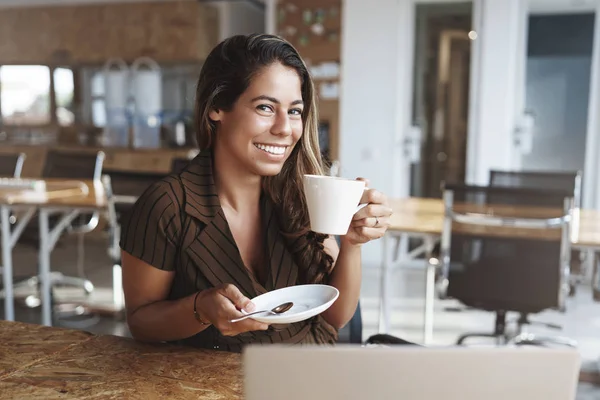 Örömteli vonzó cserzett hispán nő ülni kávézó vihog szórakozik élvezni kellemes gondtalan beszélgetést keresni kamera imádnivaló mosoly tart kis tányér kávét, pihentető barát — Stock Fotó