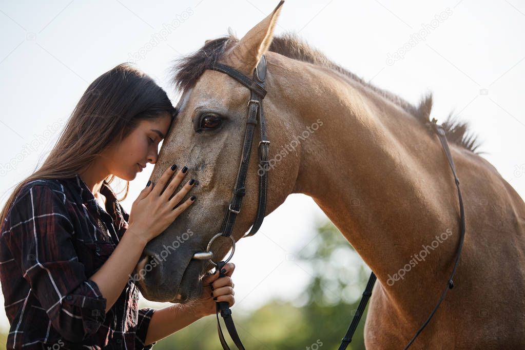 Tenderness, love and animals concept. Sensual young woman touching horses foretop, close eyes and gently brushing nose as taking care pet, adore spending time horse farm, horsewoman on rancho