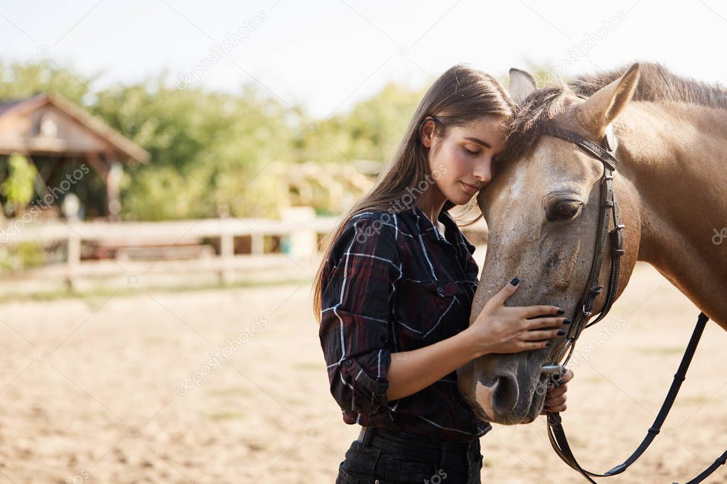 Care, tenderness and animals concept. Lovely and carefree tender young woman in checked shirt, lean on horse face, close eyes and smiling gently, petting pet nose, enjoy weekends on rancho