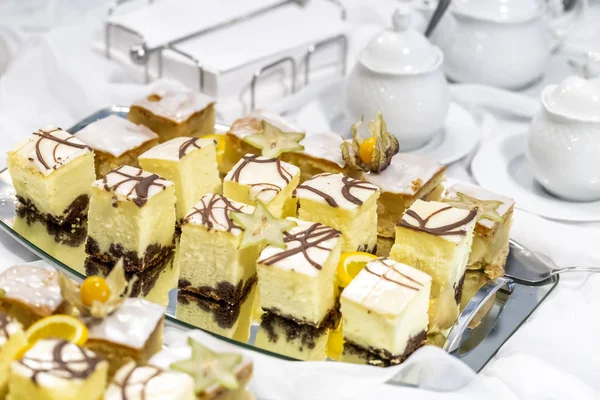 Cheesecake in pieces on a mirrored tray