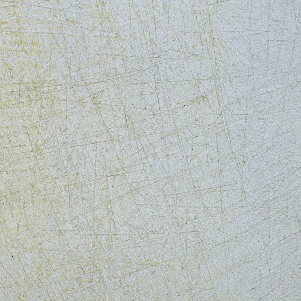 fragment of white old scratched plastic cutting board as background