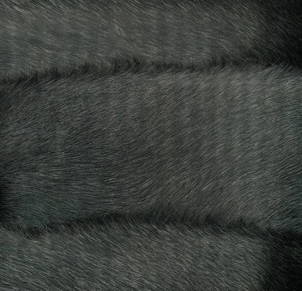 fragment of fur coat as natural black fur background