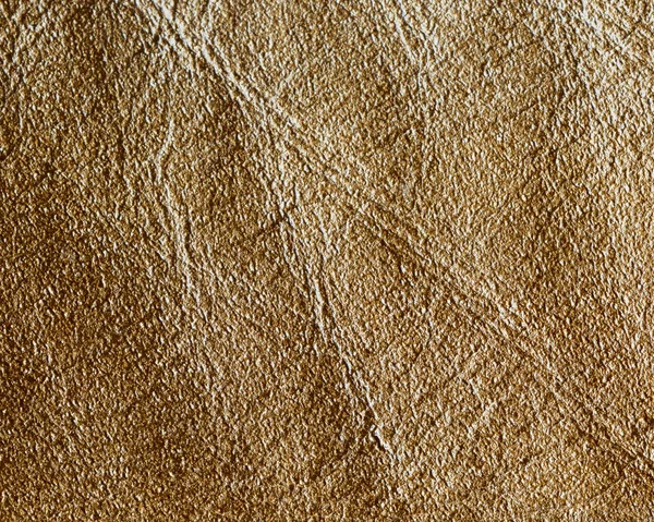 Geelbruin lederen textuur close-up als achtergrond Stockafbeelding
