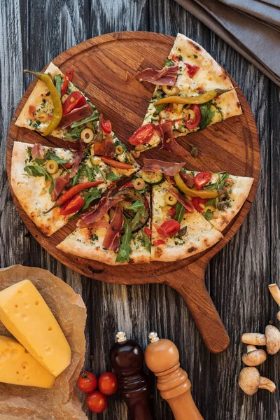 Top view of slices of pizza on wooden cutting board — Stock Image Top View Slices Pizza Wooden Cutting Board Royalty Free Stock Images