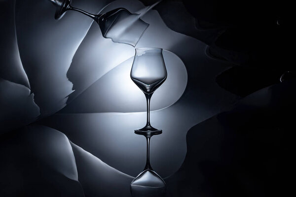 empty wine glass with geometric reflection on dark