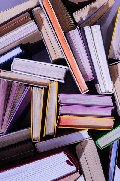 top view of scattered stack of books on table