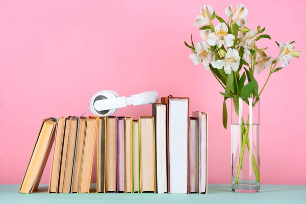 Headphones Row Books Flowers Glass Table — Stock Photo, Image