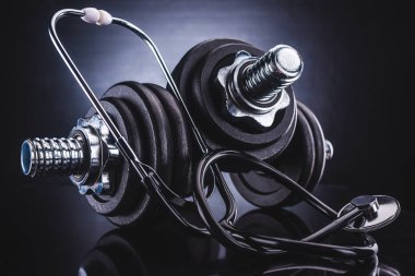 close-up view of dumbbells and stethoscope, healthy lifestyle concept clipart