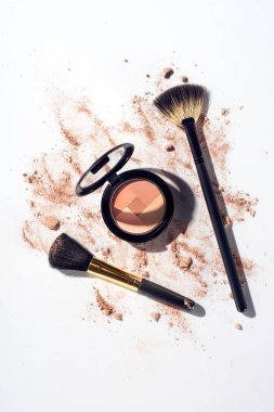 Contouring palette with makeup brushes on white background clipart
