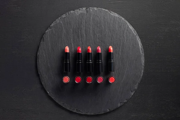 Row Red Lipsticks Slate Background — Stock Photo, Image