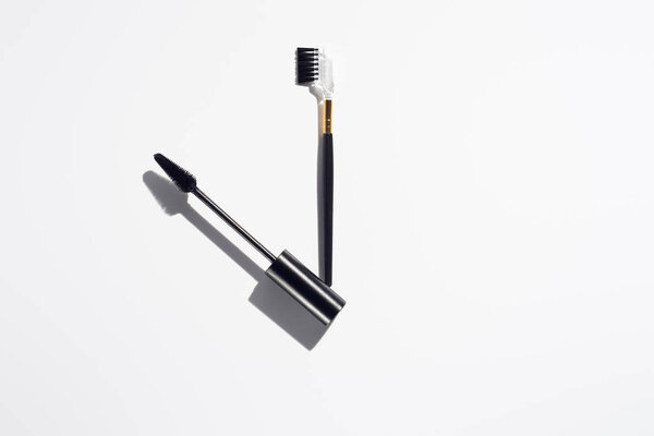 Makeup brushes for brows on white background