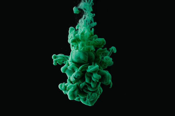 abstract flowing green paint on black background 