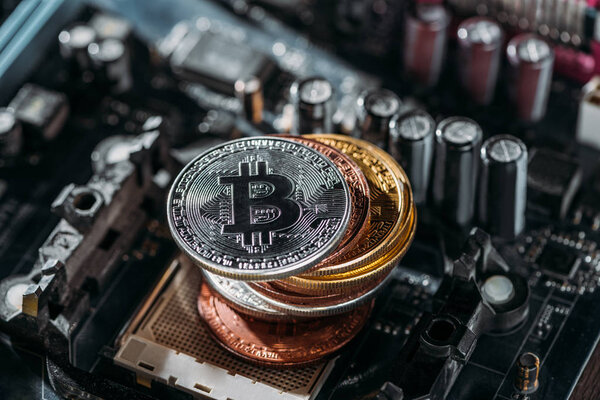 close up view of pile of bitcoins on computer motherboard