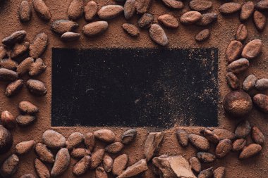 elevated view of empty surface surrounded cocoa beans covered by grated chocolate  clipart