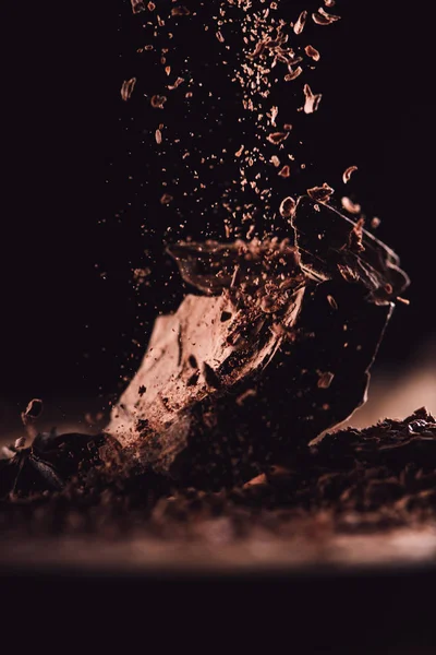 Close Image Grated Dark Chocolate Falling Pieces Chocolate Black Background — Stock Photo, Image