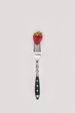 Red strawberry on a fork isolated on white background clipart