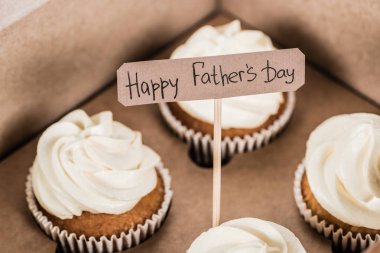 close-up shot of tasty cupcakes in box with Happy fathers day inscription clipart