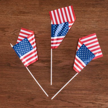 top view of united states flags on wooden surface, Independence Day concept clipart