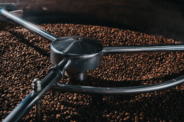 Aromatic coffee beans being roasted in professional machine