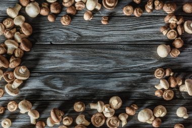 top view of frame made of champignon mushrooms on wooden surface clipart