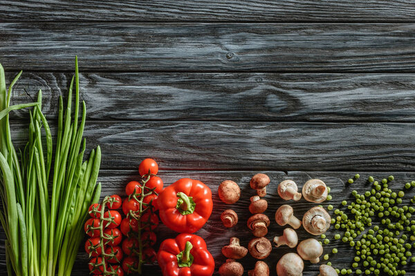 top view of various raw vegetables on wooden tabletop