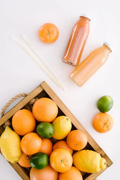 Top View Various Citrus Fruits Wooden Box Bottles Juice White — Free Stock Photo