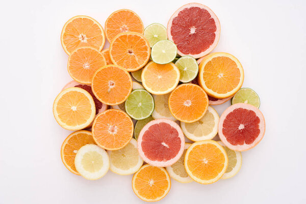 top view of heap of various citrus fruits slices isolated on white surface