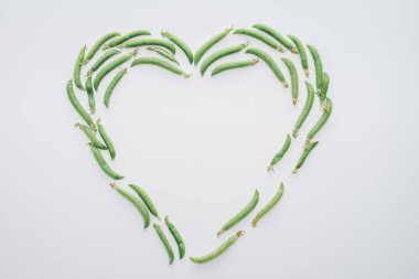 top view of heart made of fresh green peas isolated on white  clipart