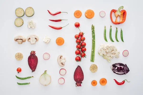 top view of fresh raw sliced vegetables isolated on white