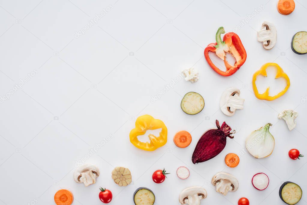 top view of slices of fresh healthy vegetables isolated on white background 