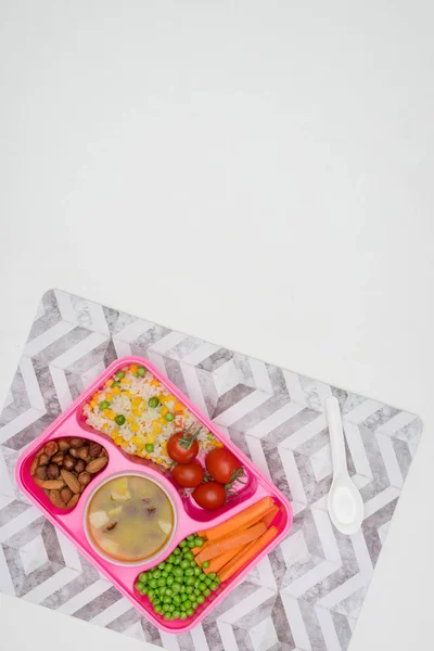 top view of tray with kids lunch for school on napkin isolated on white