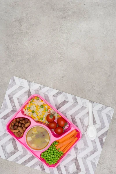 top view of tray with kids lunch for school on napkin on marble table
