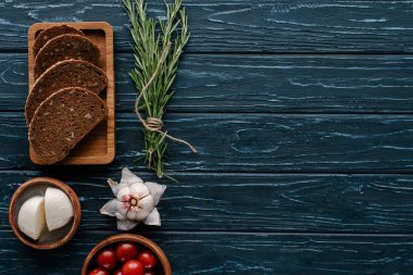 Mozzarella peyniri ve domates biberiye ve sarımsak ile koyu ahşap tablo