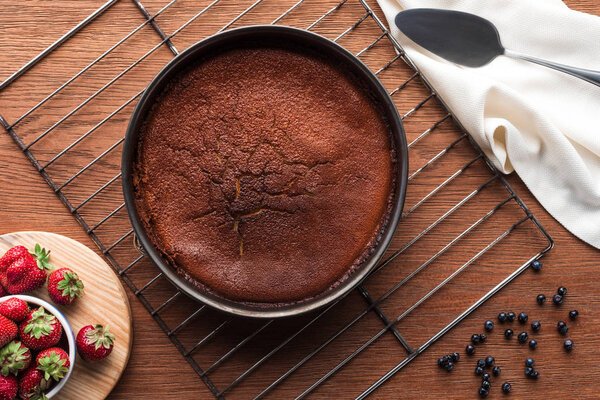 вид на вкусный домашний кекс и свежие ягоды на деревянном столе
 