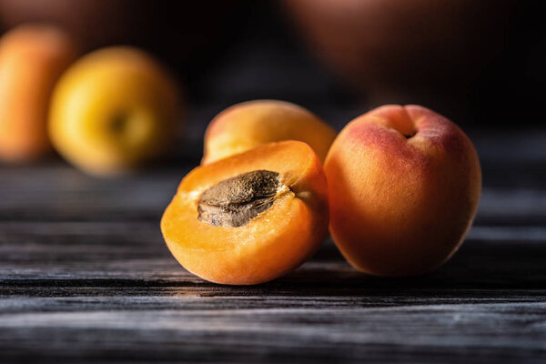 selective focus of ripe apricots on wooden table
