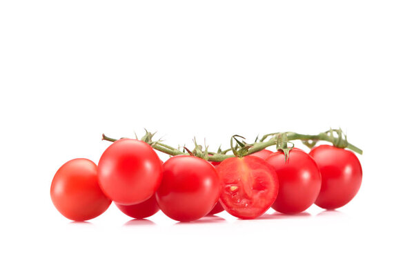 close up view of ripe cherry tomatoes on twig isolated on white
