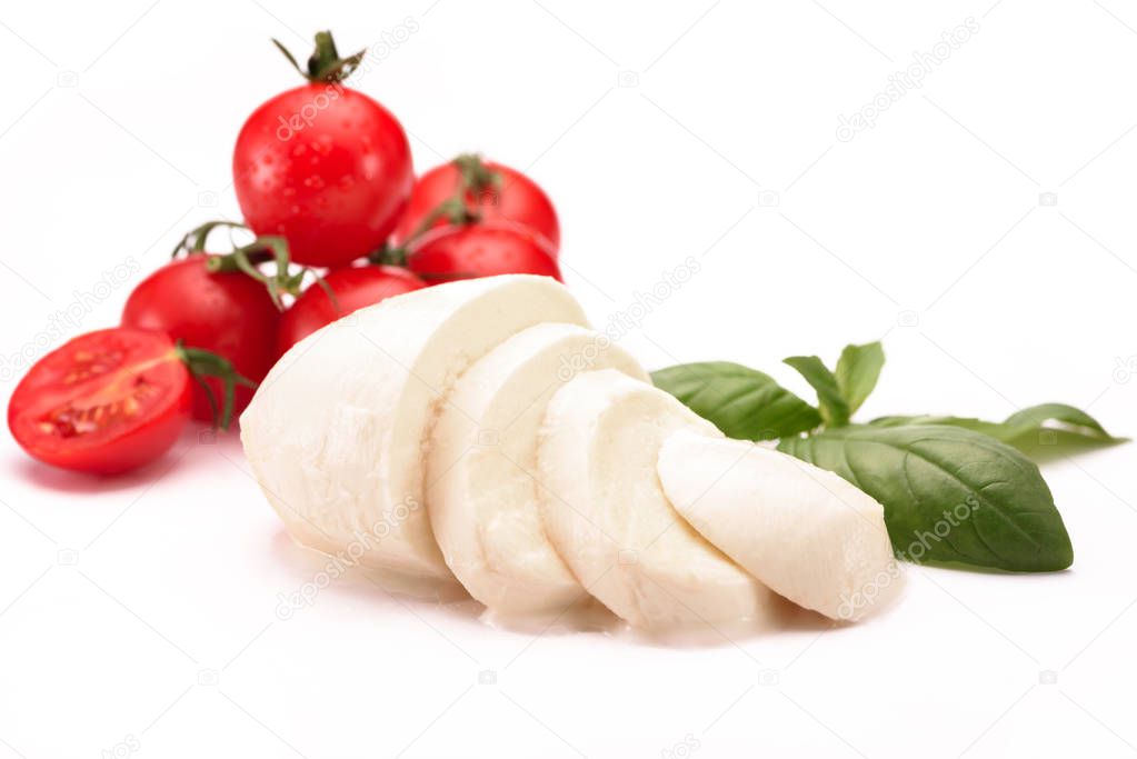 close up view of cherry tomatoes, mozzarella cheese and basil leaves isolated on white