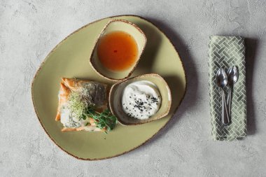 flat lay with samosas in Phyllo dough stuffed with spinach and paneer decorated with germinated seeds of alfalfa and sunflower served on plate on grey tabletop clipart