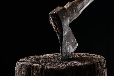  close up view of vintage axe on wooden stump isolated on black clipart