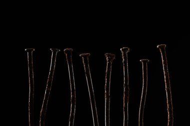 close up view of vintage rusty nails isolated on black clipart
