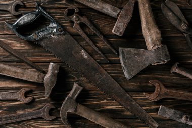 flat lay with assortment of vintage rusty tools on wooden surface clipart