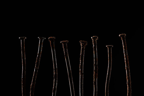 close up view of vintage rusty nails isolated on black